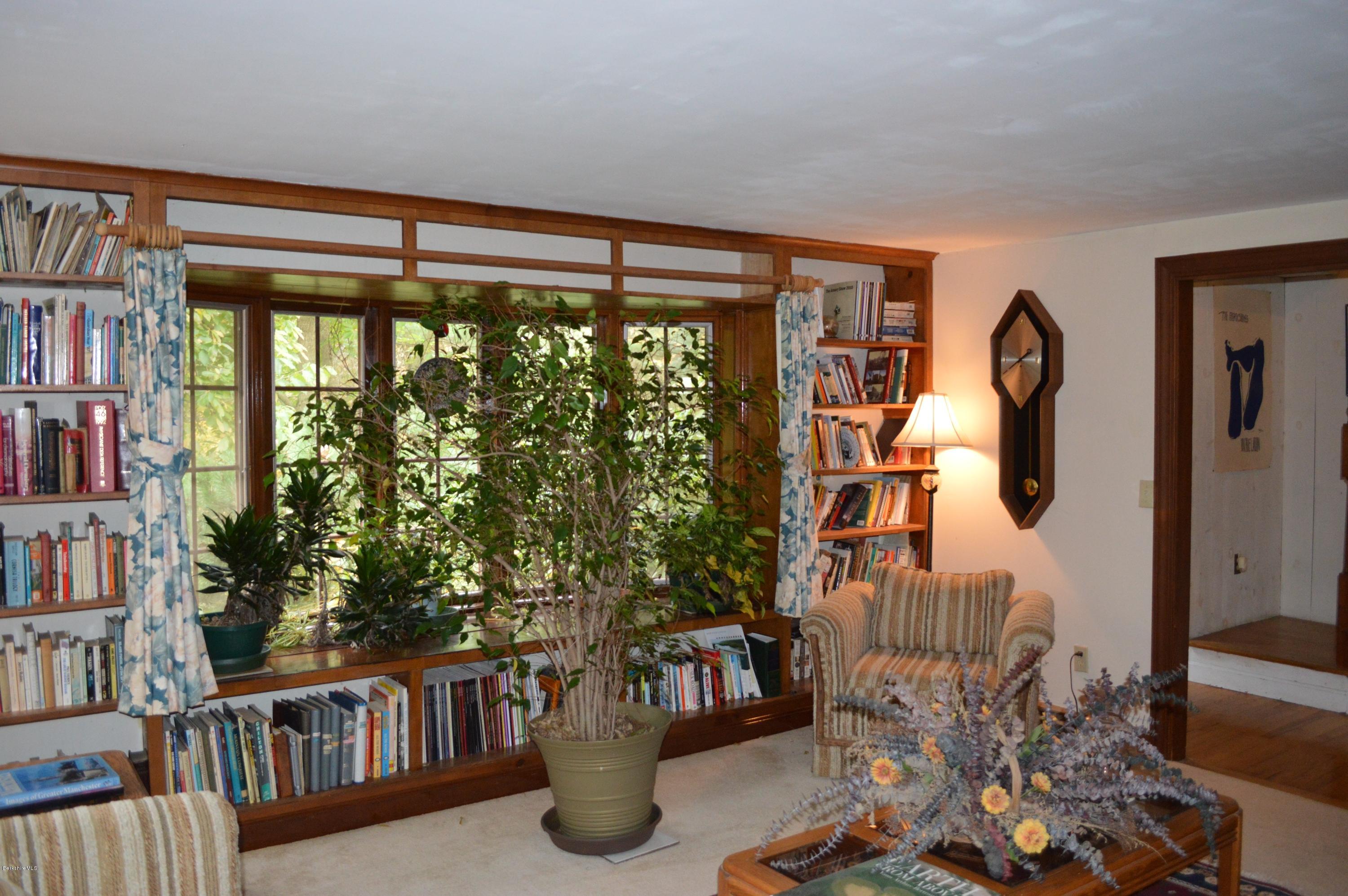67 Main Road Tyringham, MA 01238 - Photo 4 of 20 a living room with furniture and a book shelf
