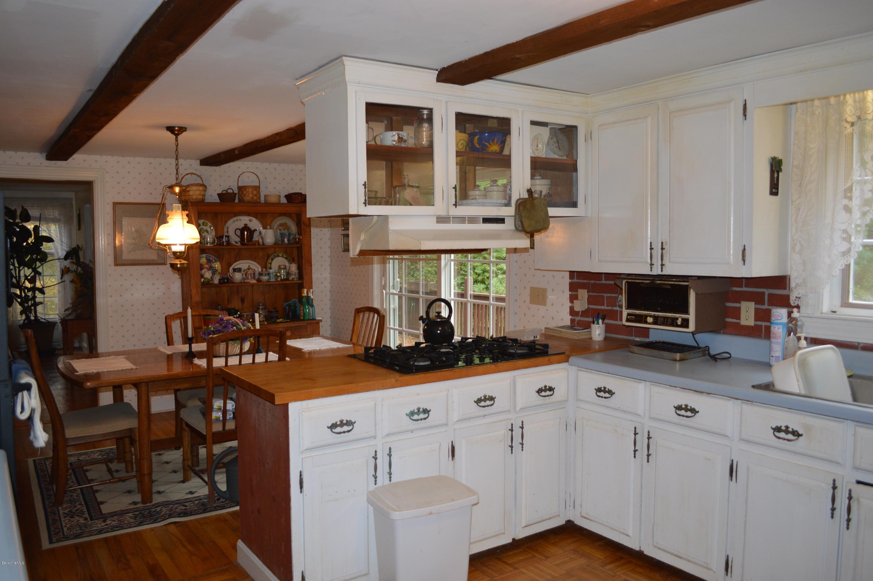 67 Main Road Tyringham, MA 01238 - Photo 5 of 20 a kitchen with kitchen island granite countertop a sink cabinets and window