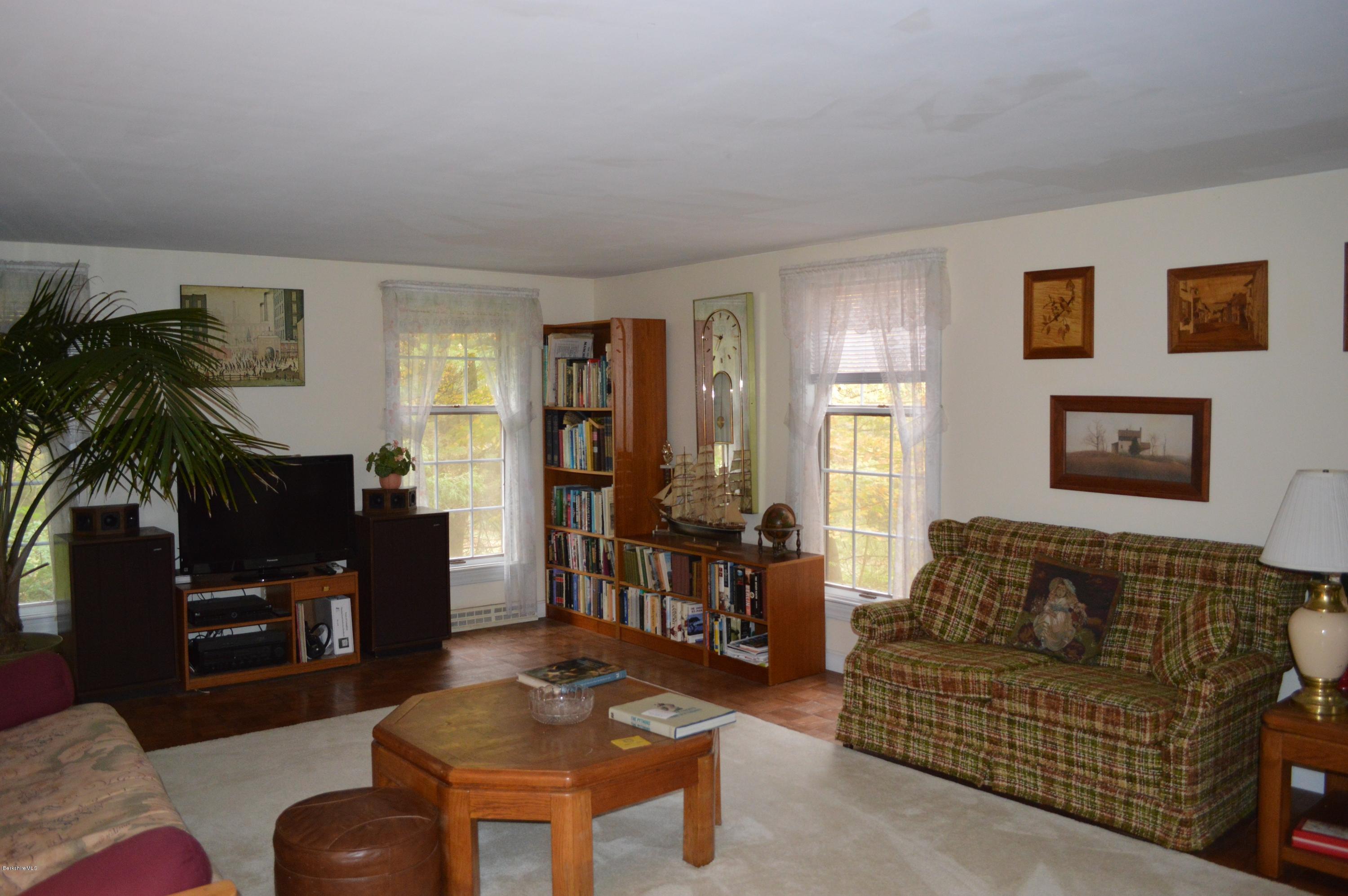 67 Main Road Tyringham, MA 01238 - Photo 8 of 20 a living room with furniture and a fireplace