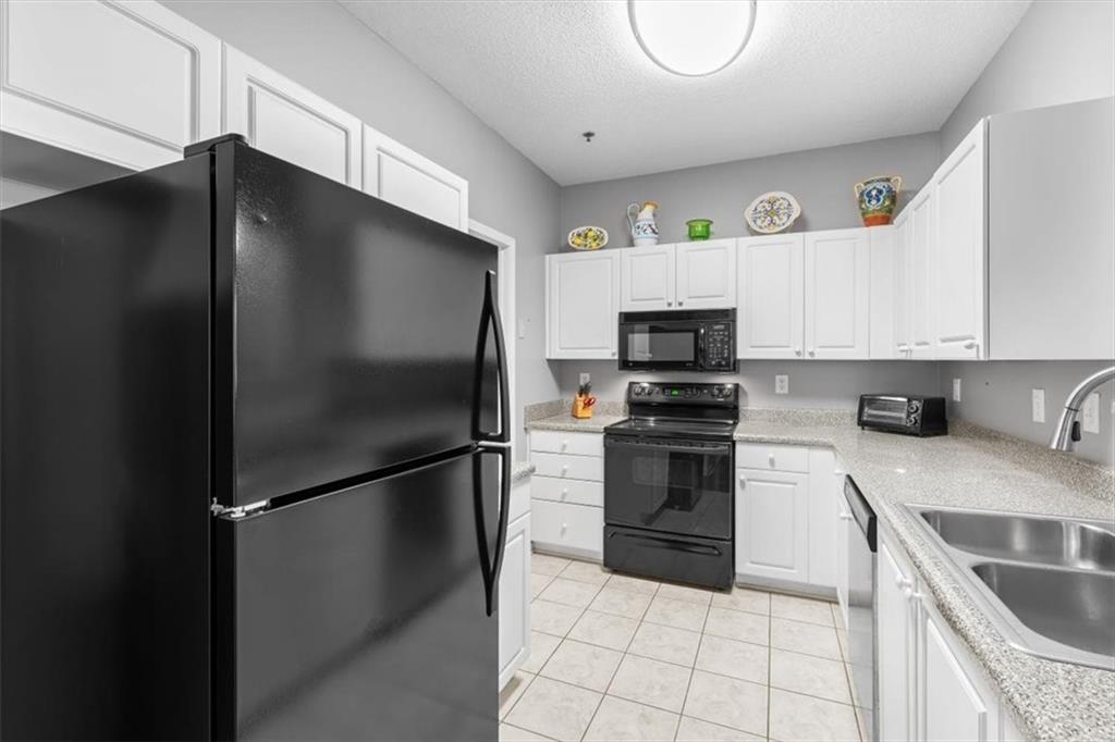 803 Spring Heights Lane Smyrna, GA 30080 - Photo 11 of 40 a kitchen with a refrigerator and a stove top oven