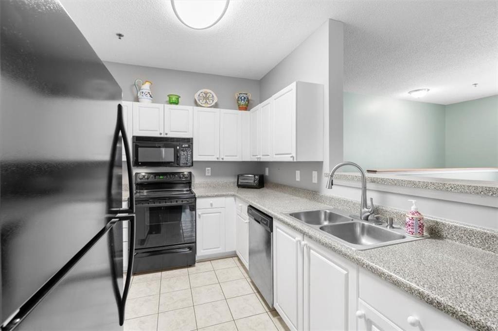803 Spring Heights Lane Smyrna, GA 30080 - Photo 13 of 40 a kitchen with a sink a refrigerator and cabinets