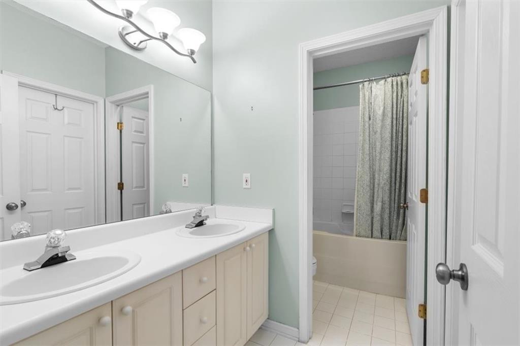 803 Spring Heights Lane Smyrna, GA 30080 - Photo 22 of 40 a bathroom with a sink a mirror and a shower