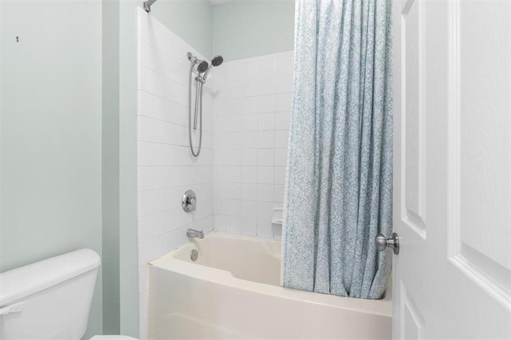 803 Spring Heights Lane Smyrna, GA 30080 - Photo 23 of 40 a bathroom with a tub and a shower curtain