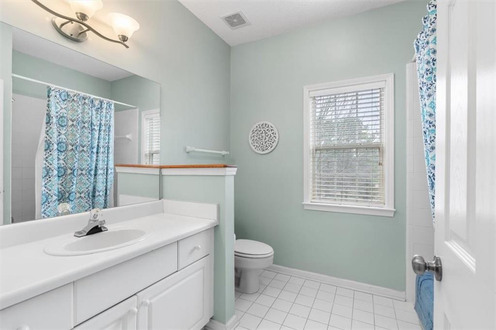 803 Spring Heights Lane Smyrna, GA 30080 - Photo 26 of 40 a bathroom with a sink toilet vanity and window