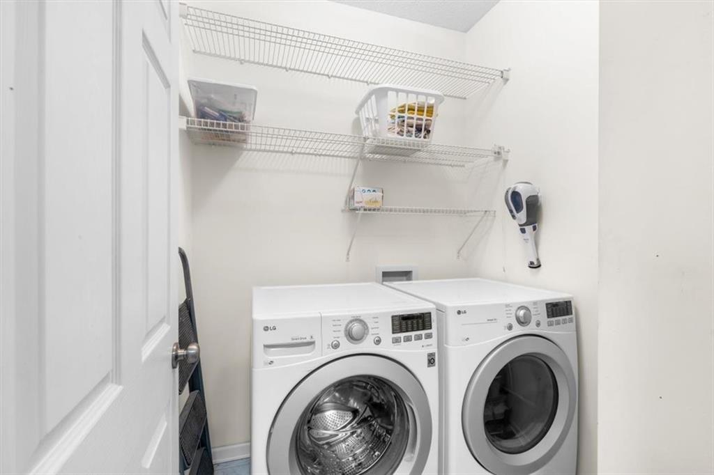 803 Spring Heights Lane Smyrna, GA 30080 - Photo 27 of 40 a view of washer and dryer with kitchen in the background