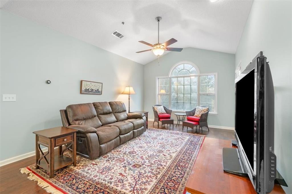 803 Spring Heights Lane Smyrna, GA 30080 - Photo 6 of 40 a living room with furniture a chandelier and a window