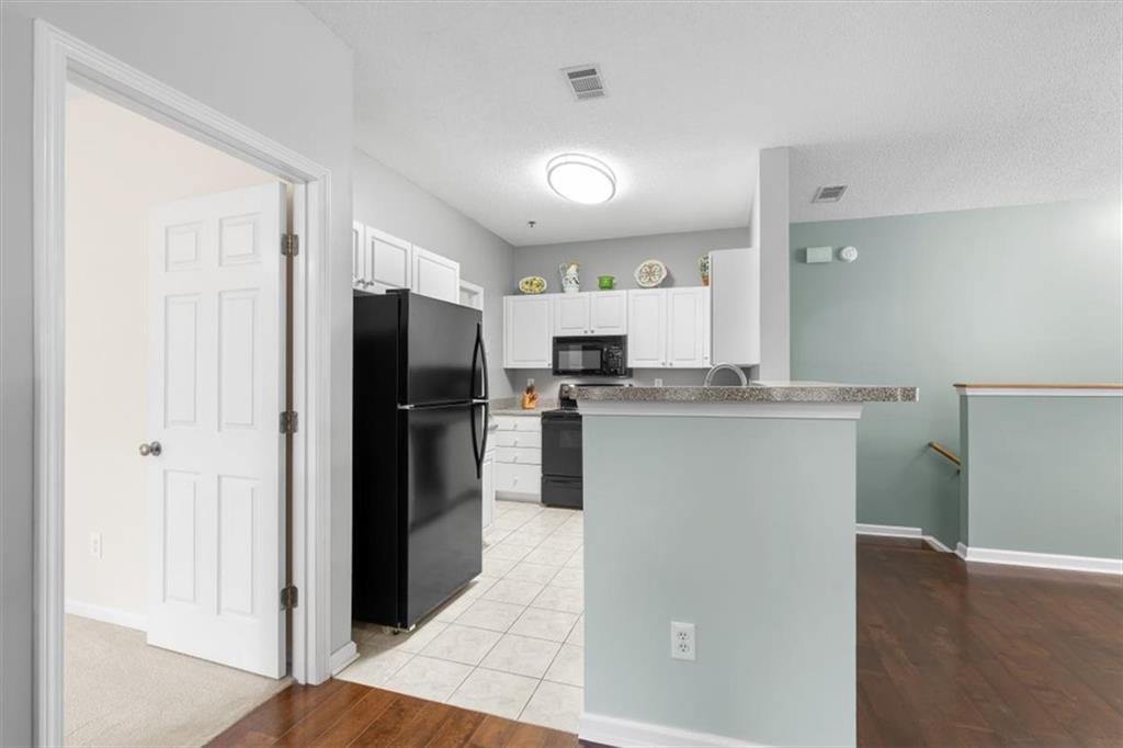 803 Spring Heights Lane Smyrna, GA 30080 - Photo 10 of 40 a kitchen with kitchen island a refrigerator a stove a sink and a cabinets