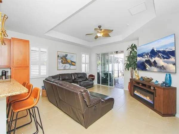 a view of a kitchen with a sink and dishwasher a fireplace with wooden floor