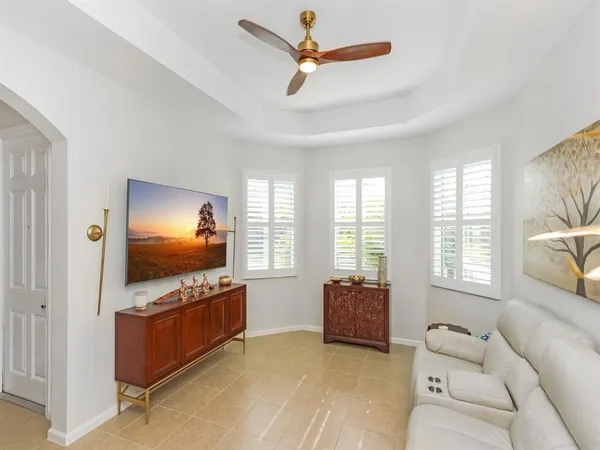 a living room with furniture and a flat screen tv with wooden floor