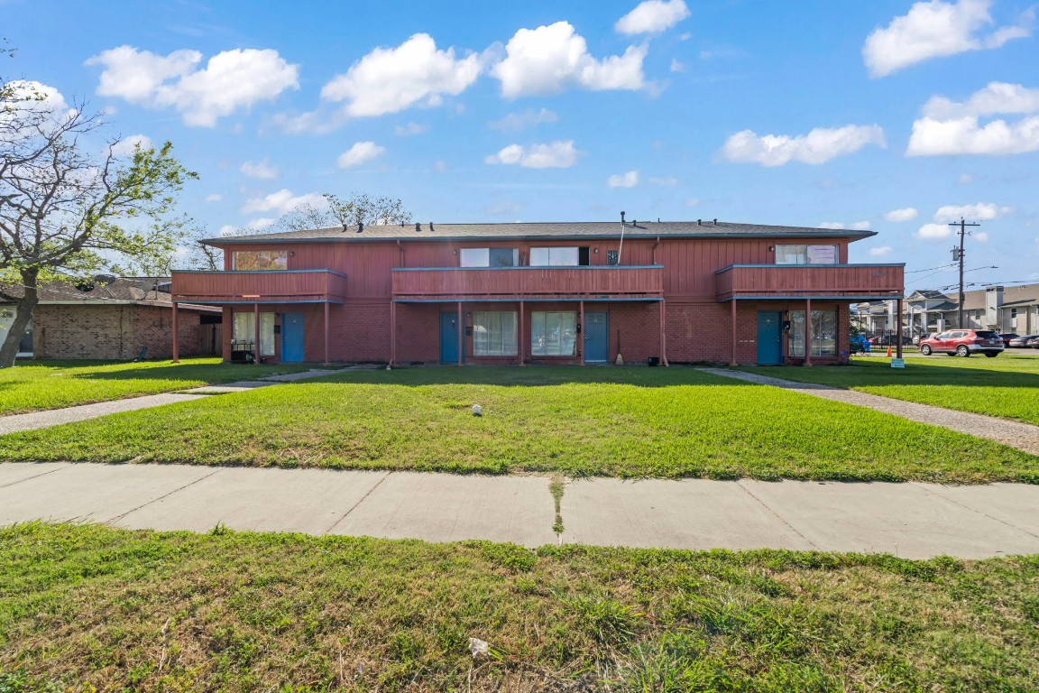 2816 Lafferty Road, Unit 4 Pasadena, TX 77502 - Photo 19 of 34 a view of a brick house next to a yard with big trees