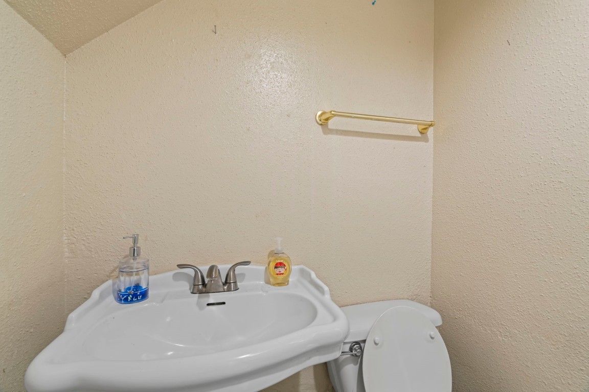 2816 Lafferty Road, Unit 4 Pasadena, TX 77502 - Photo 8 of 34 a bathroom with a sink a toilet and a mirror