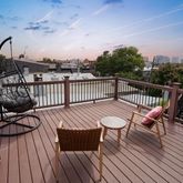 a view of balcony with wooden floor and outdoor seating
