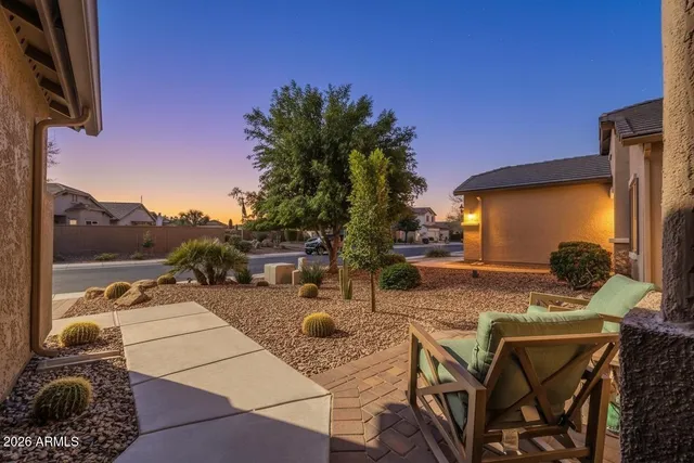 a backyard of a house with a fountain table and chairs