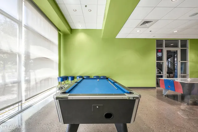 an aerial view of a house with a yard and large tree