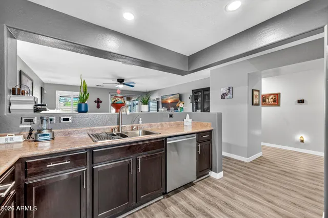 a kitchen with a table chairs refrigerator and a window