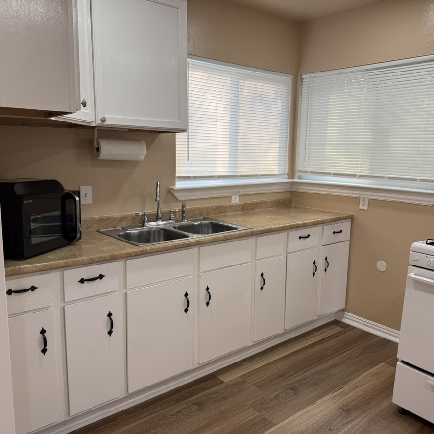 3402 Seabrook Street Houston, TX 77021 - Photo 12 of 18 a kitchen with granite countertop white cabinets white appliances and a wide window