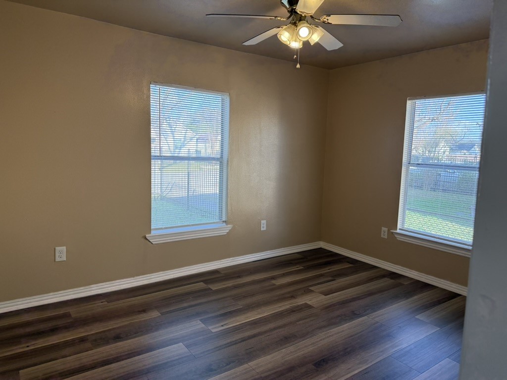 3402 Seabrook Street Houston, TX 77021 - Photo 8 of 18 a view of an empty room with wooden floor and a window