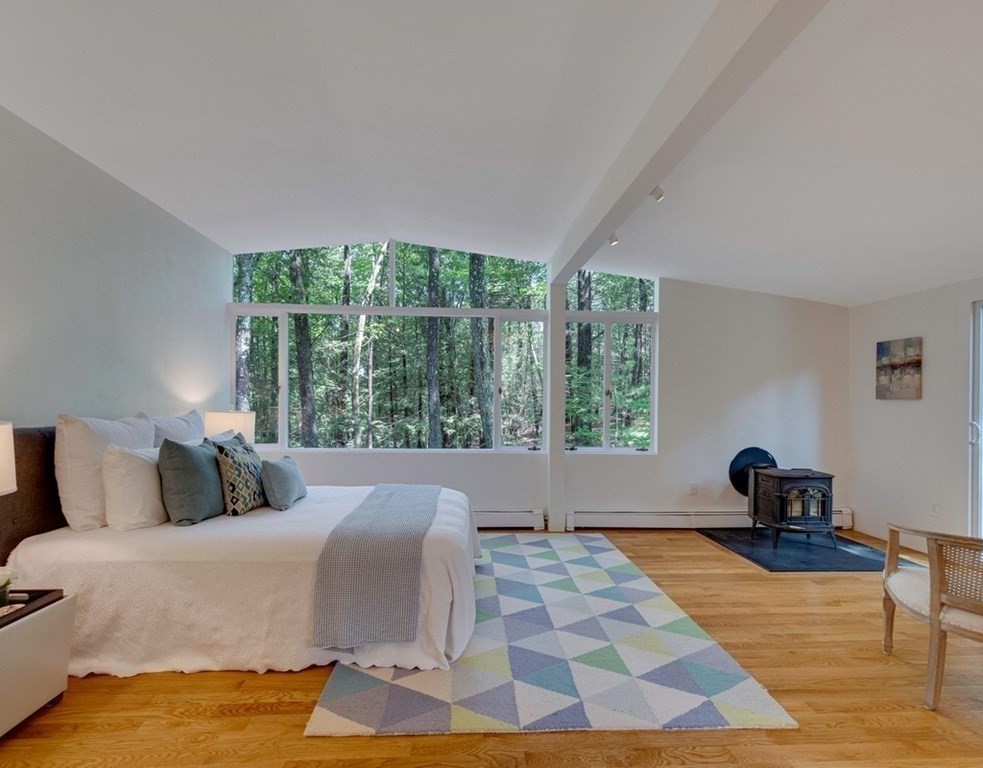 64 Baker Bridge Road Lincoln, MA 01773 - Photo 17 of 34 a bedroom with a bed and wooden floor