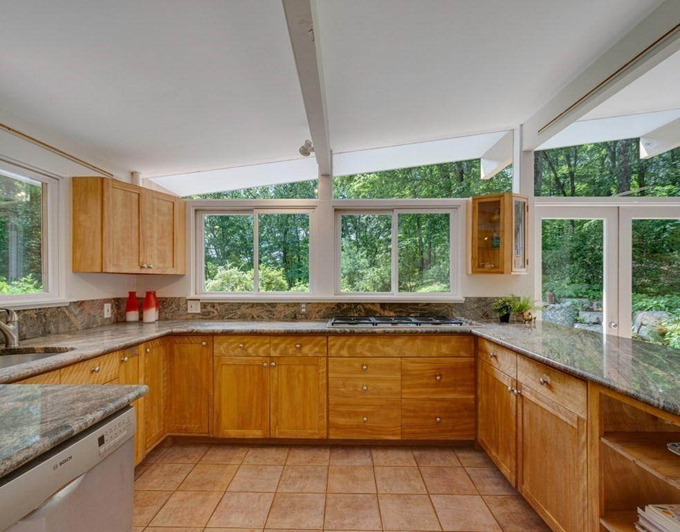 64 Baker Bridge Road Lincoln, MA 01773 - Photo 5 of 34 a large kitchen with a large window sink and cabinets