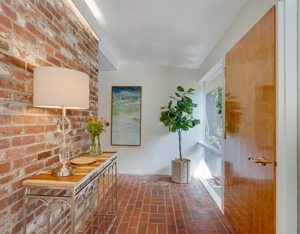 64 Baker Bridge Road Lincoln, MA 01773 - Photo 6 of 34 a living room with furniture and a potted plant