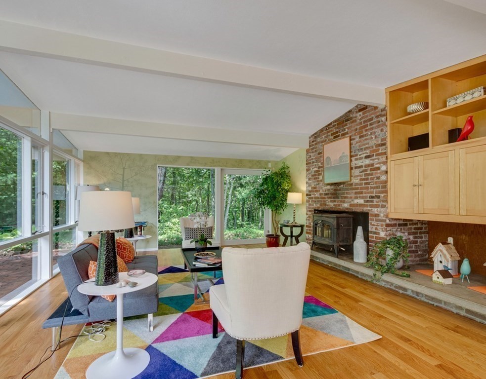 64 Baker Bridge Road Lincoln, MA 01773 - Photo 8 of 34 a living room with furniture fireplace and a table