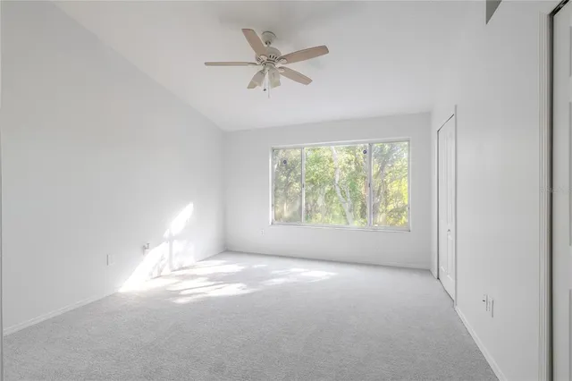 a view of a chandelier fan and refrigerator in a room