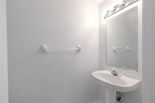 a bathroom with a sink a mirror and a toilet