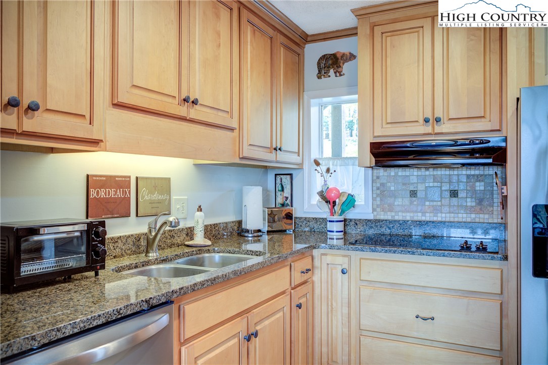 367 Skyleaf Drive, Unit D8 Banner Elk, NC 28604 - Photo 12 of 43 a kitchen with stainless steel appliances granite countertop a sink a stove and cabinets