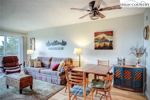 a bedroom with a bed and a flat tv screen on dresser