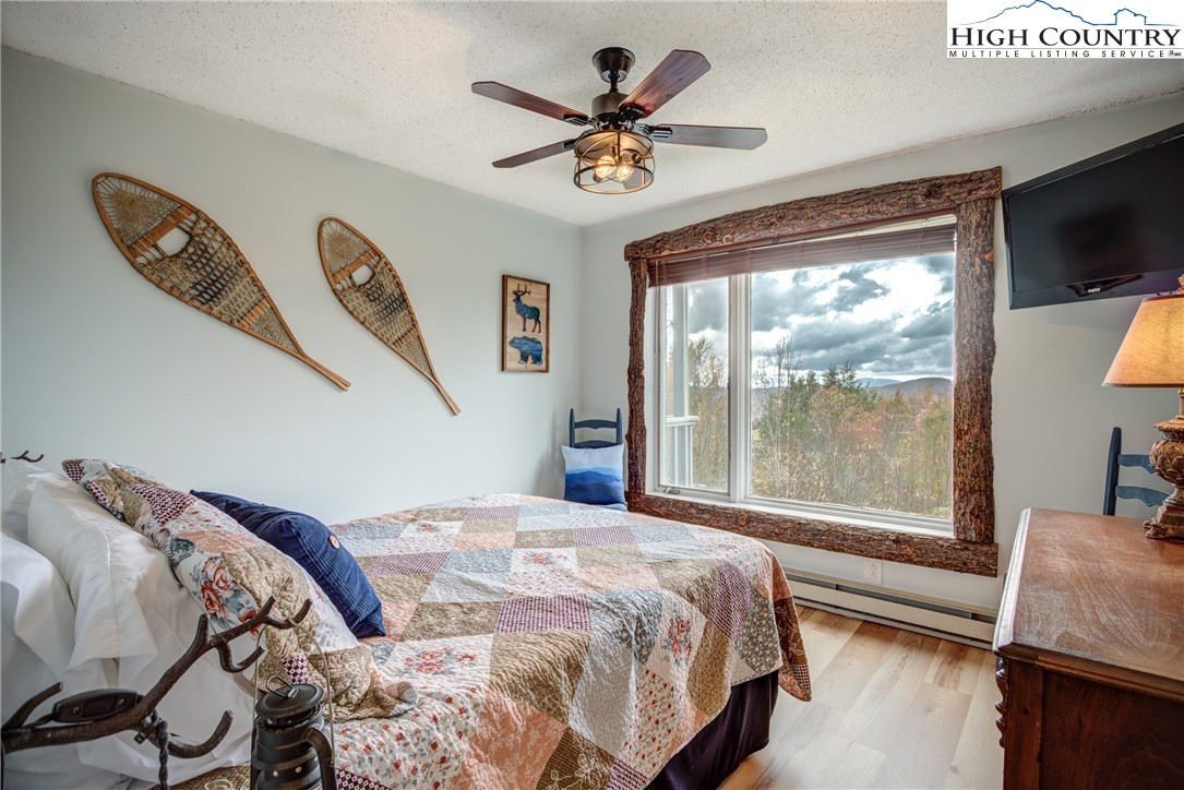 367 Skyleaf Drive, Unit D8 Banner Elk, NC 28604 - Photo 15 of 43 a bedroom with a large bed and a large window