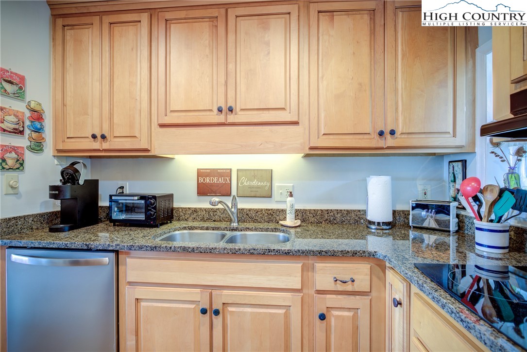 367 Skyleaf Drive, Unit D8 Banner Elk, NC 28604 - Photo 19 of 43 a kitchen with granite countertop cabinets and white appliances