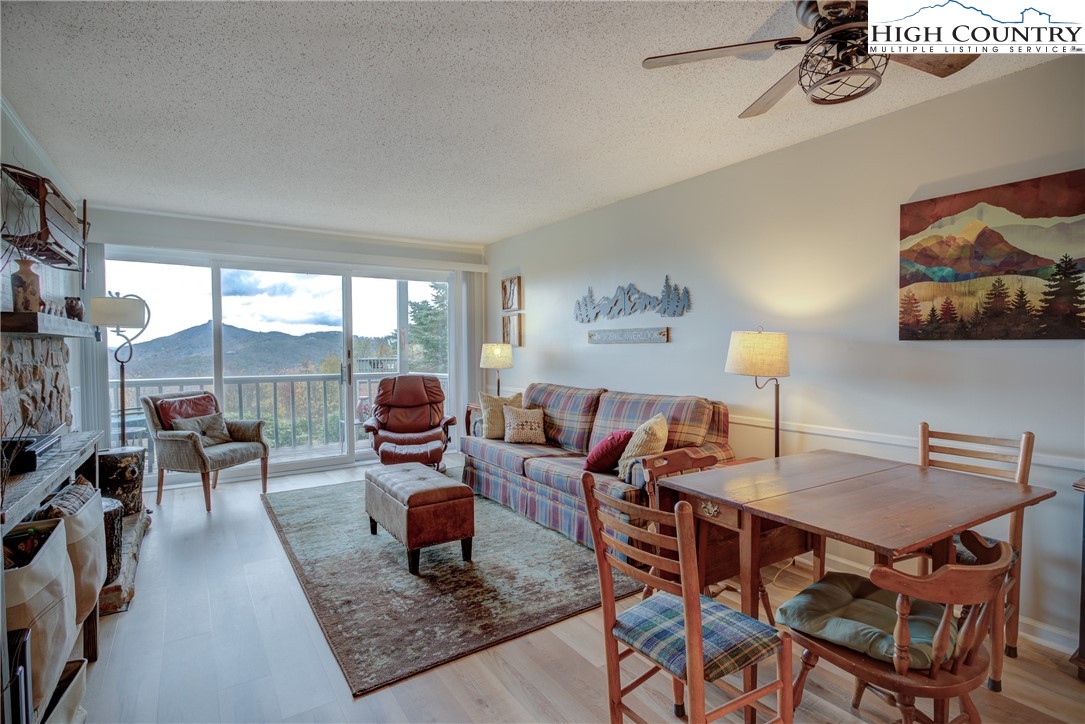 367 Skyleaf Drive, Unit D8 Banner Elk, NC 28604 - Photo 8 of 43 a living room with furniture and a floor to ceiling window