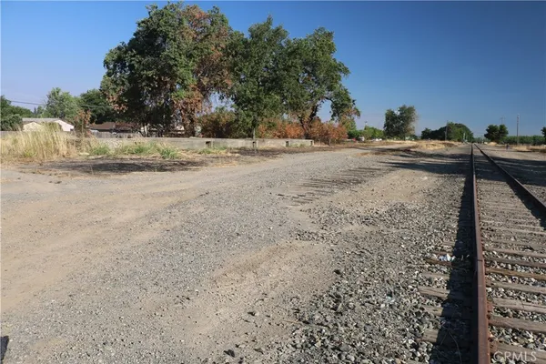 a view of a yard with wooden fence