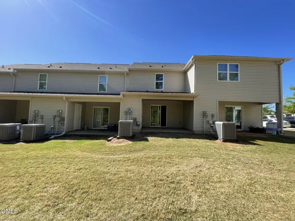 a view of a house with swimming pool and a yard