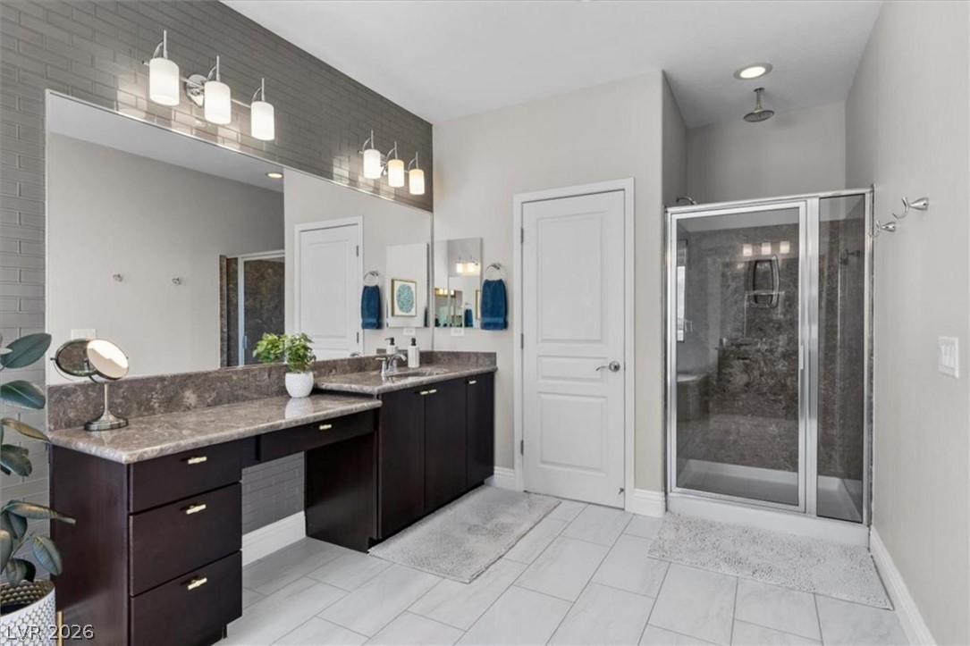 10334 Mopan Road Las Vegas, NV 89178 - Photo 17 of 28 A walk-in shower with a built in bench completes the primary bath.