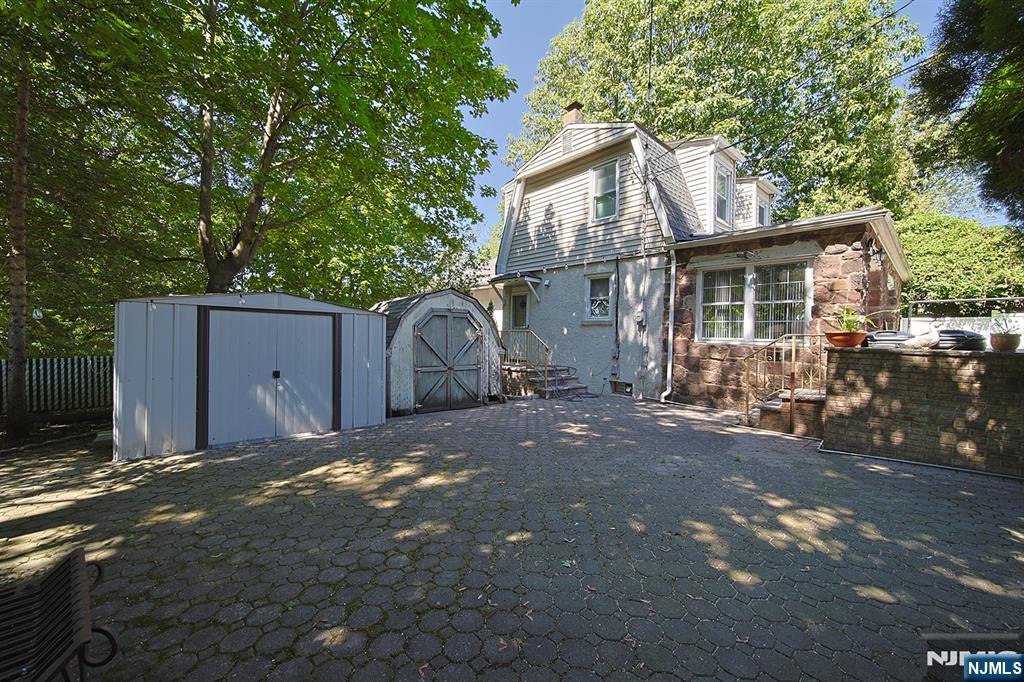1585 Bergen Boulevard Leonia, NJ 07605 - Photo 14 of 50 a view of a house with a backyard and a garage