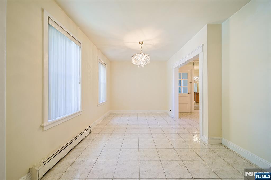 1585 Bergen Boulevard Leonia, NJ 07605 - Photo 15 of 50 a view of an empty room with window and chandelier fan