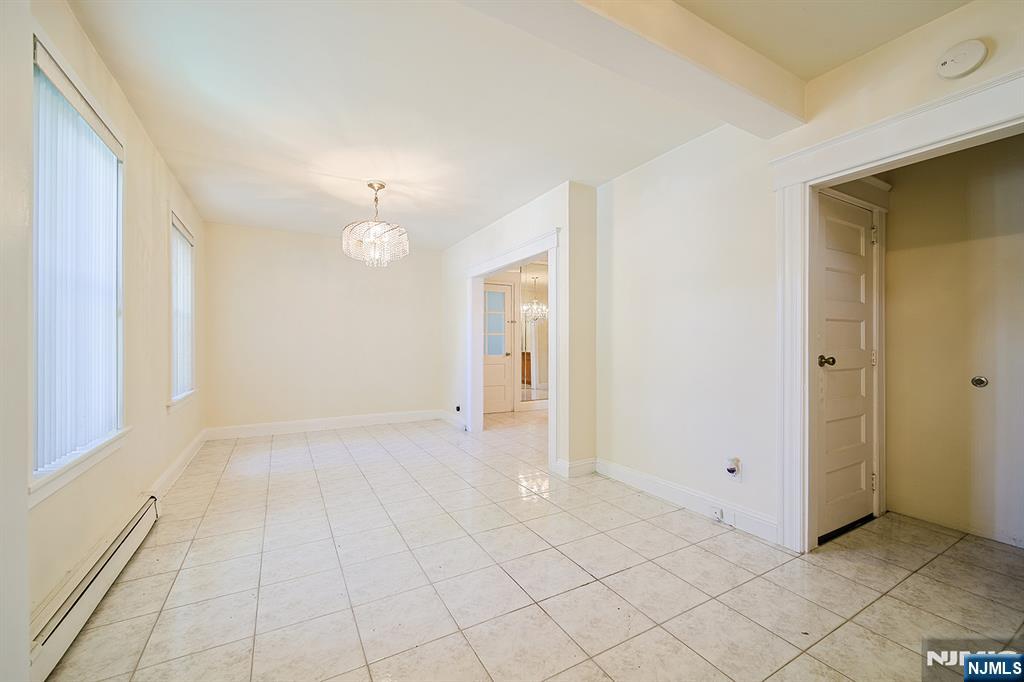 1585 Bergen Boulevard Leonia, NJ 07605 - Photo 16 of 50 a view of an empty room with window and chandelier fan