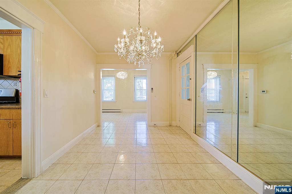 1585 Bergen Boulevard Leonia, NJ 07605 - Photo 23 of 50 a view of a hallway with wooden floor and a chandelier