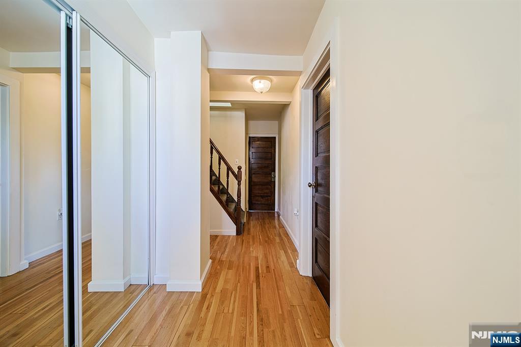 1585 Bergen Boulevard Leonia, NJ 07605 - Photo 33 of 50 a view of a hallway with wooden floor and staircase