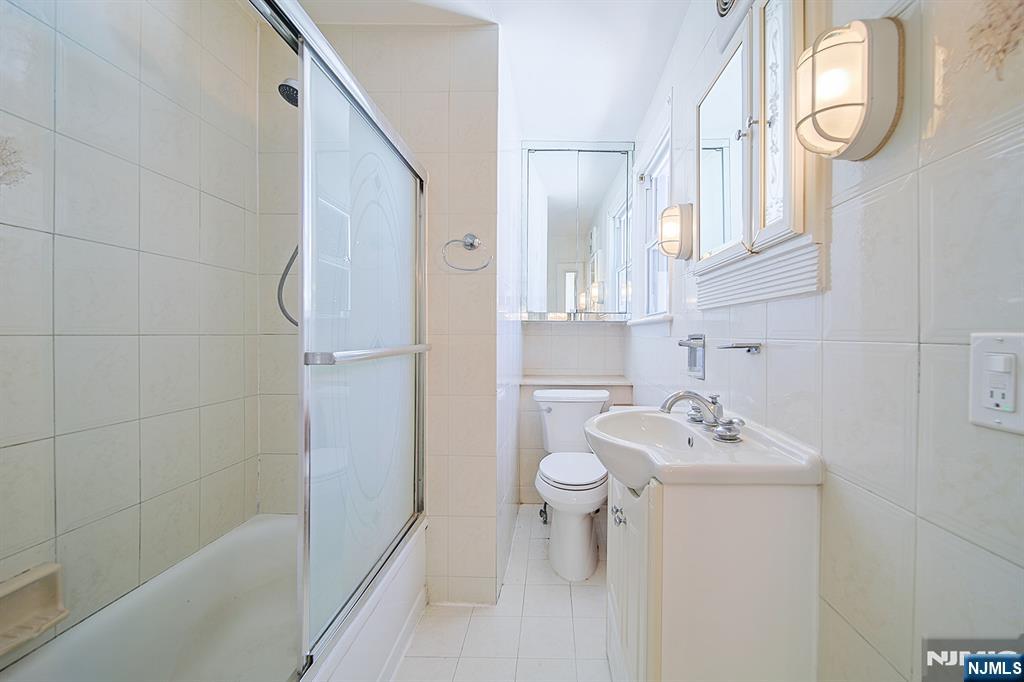 1585 Bergen Boulevard Leonia, NJ 07605 - Photo 36 of 50 a bathroom with a sink toilet and shower