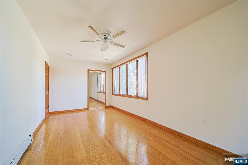 1585 Bergen Boulevard Leonia, NJ 07605 - Photo 39 of 50 a view of an empty room with wooden floor and a window