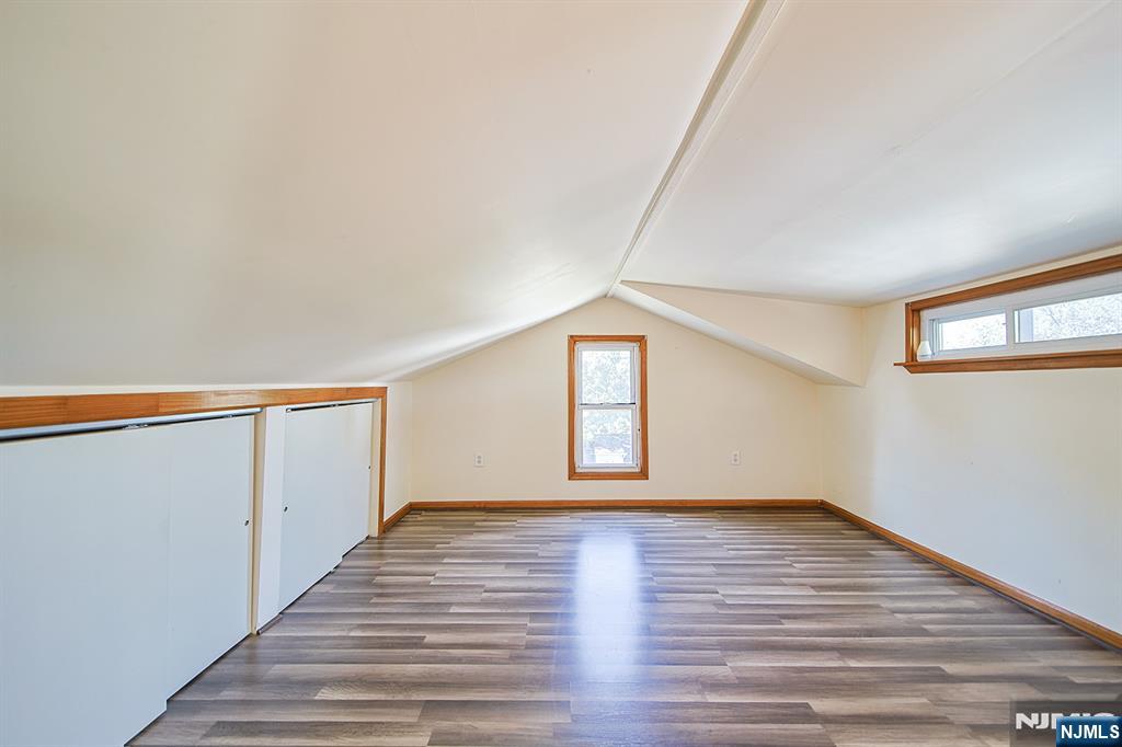 1585 Bergen Boulevard Leonia, NJ 07605 - Photo 45 of 50 a view of an empty room with wooden floor and a window