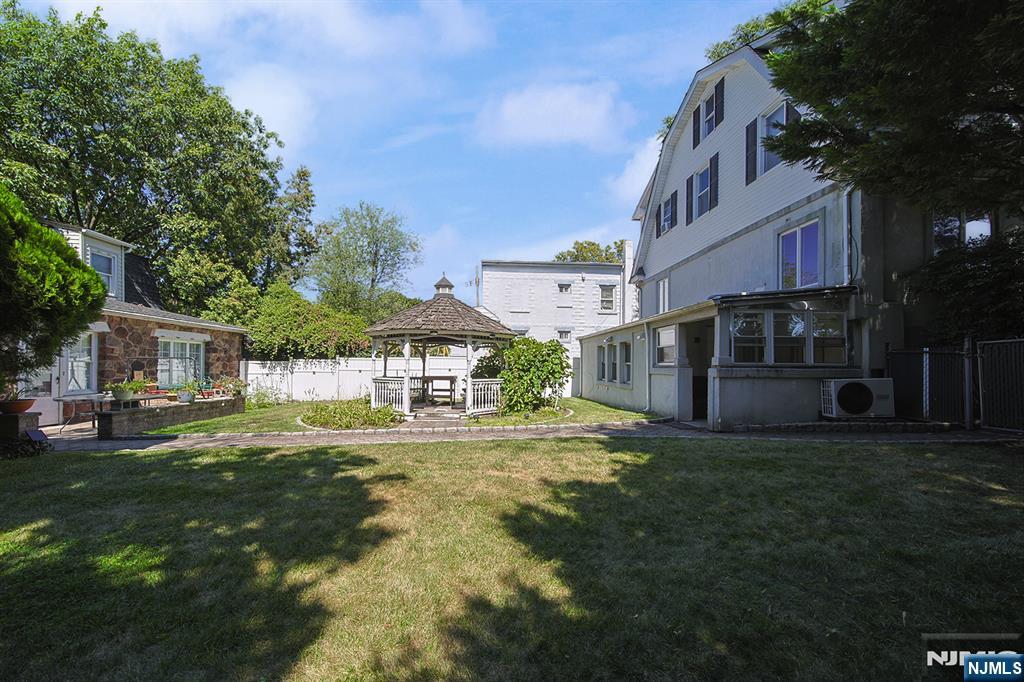 1585 Bergen Boulevard Leonia, NJ 07605 - Photo 6 of 50 a front view of a house with a garden