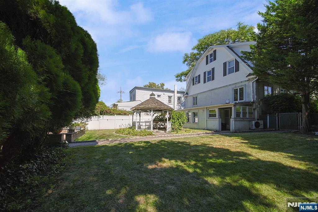 1585 Bergen Boulevard Leonia, NJ 07605 - Photo 7 of 50 a front view of a house with a garden