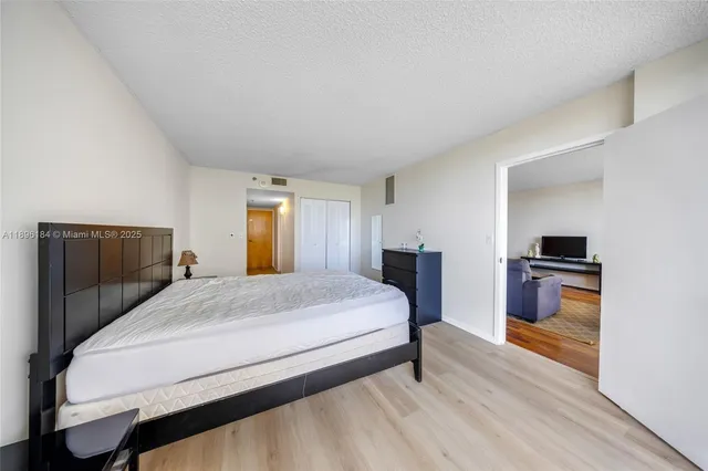 a spacious bedroom with a bed and window