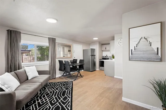 a living room with furniture potted plant and a window