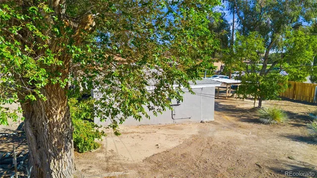 a view of a white house with a yard