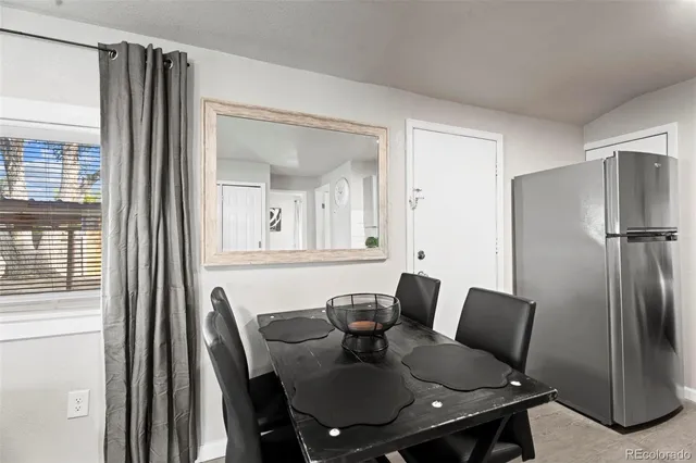 a view of a dining room with furniture and a potted plant