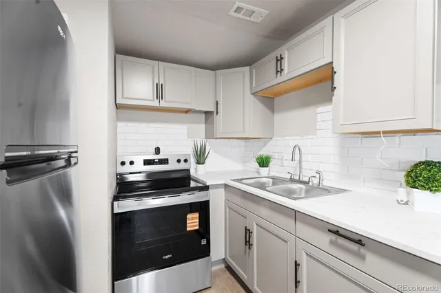 a kitchen with a sink and a stove top oven